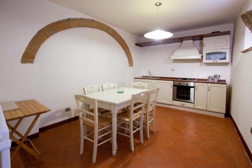 a kitchen with a table and chairs in a room at Borgo alle Mura in Casale Marittimo
