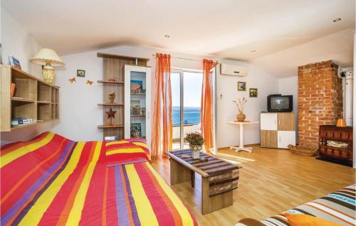 a bedroom with a bed and a view of the ocean at Beautiful Apartment In Karlobag With Wifi in Barić Draga