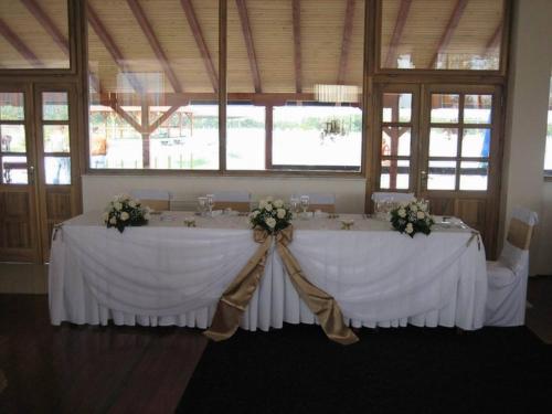 a wedding table with white tablecloths and flowers at Bazeni Baikal in Topola