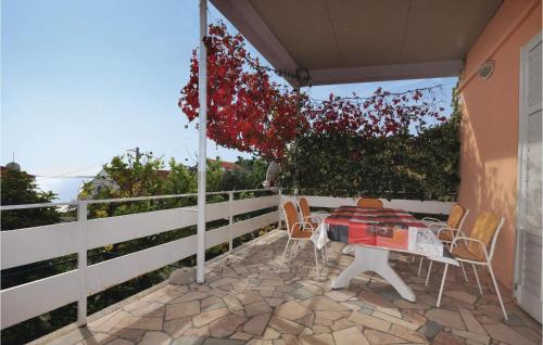 a patio with a table and chairs and a fence at Awesome Home In Seget Vranjica With Wifi in Seget Vranjica
