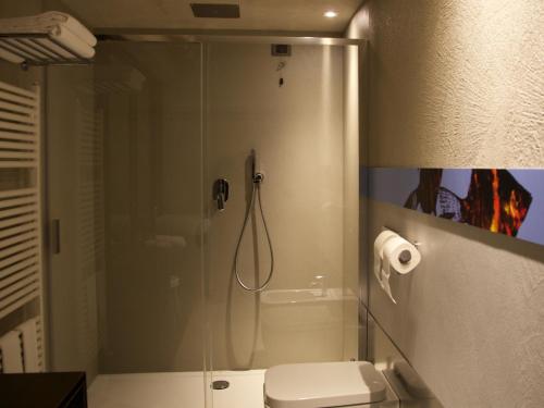 a bathroom with a shower, toilet, and sink at Hotel Locanda del Benaco in Salò