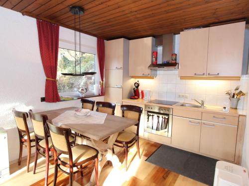 a kitchen with a table and chairs in a room at Comfy Chalet in Niedernsill with Fireplace in Niedernsill