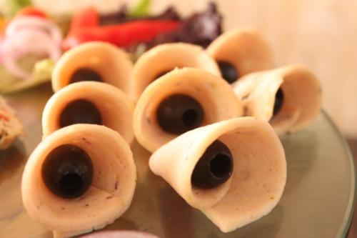 a group of eggroll bowls with eyes on a glass plate at Ramada Jamshedpur Bistupur in Jamshedpur