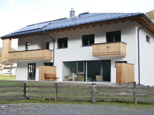 a white house with solar panels on it at Lovely Chalet in Salzburg with Mountain View in Saalbach-Hinterglemm