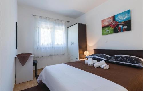 a bedroom with a large bed with two pillows on it at Awesome Apartment In Klek With 1 Bedrooms And Wifi in Klek