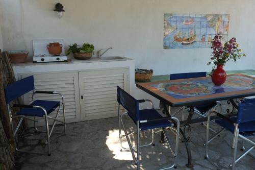 a kitchen with a table and chairs and a counter at Bilocale Elena 40mq in Conca dei Marini