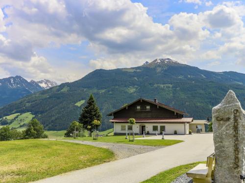 a house with mountains in the background with a road at Rustic country house in Mittersill near ski area in Mittersill