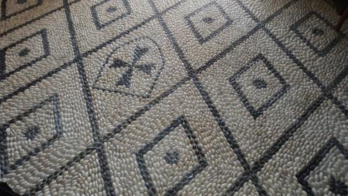 a close up of a beige floor with writing on it at Mystic Hotel - Adults only in Rhodes Town