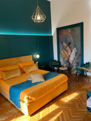 a bedroom with a large bed with a blue wall at La Lepre felice-bovio in Naples