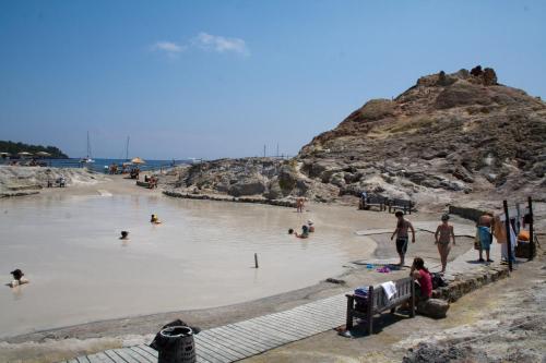 a group of people in the water at a beach at Villa Crimi in Vulcano