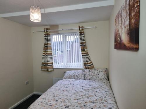 a bedroom with a bed and a window at Nice Residential Within Easy Reach Of Town in Manchester