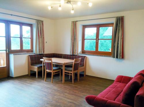a living room with a table and chairs and a couch at Ferienwohnungen Widlroither in Mondsee