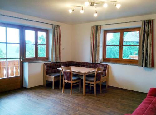 a living room with a table and chairs and a couch at Ferienwohnungen Widlroither in Mondsee