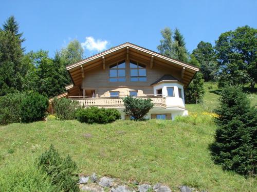 a house on top of a grassy hill at Chalet in Saalbach Hinterglemm in ski area in Viehhofen