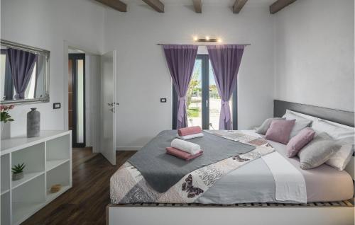 1 dormitorio con 1 cama grande y cortinas moradas en Lovely Home In Rovinj With Kitchen en Rovinj
