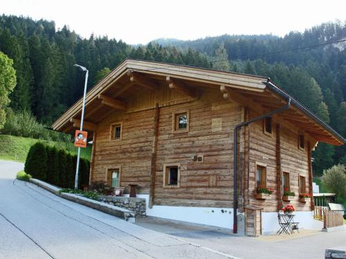 eine Holzhütte mit einem Dach an der Straßenseite in der Unterkunft Beautiful detached chalet in Mayrhofen Ramsau Tyrol with sauna in Ramsau im Zillertal