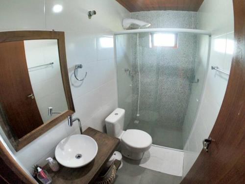 a bathroom with a shower and a toilet and a sink at Excelente Casa na Praia da Gamboa a 200 metros da Praia! in Garopaba