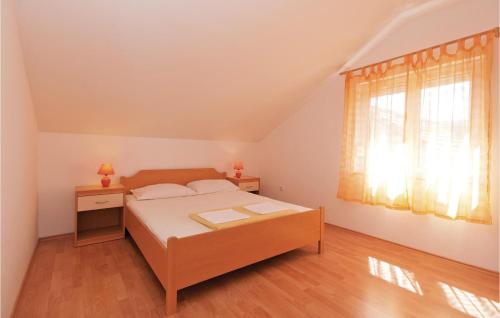 a bedroom with a bed and a window at Awesome Apartment In Krusevo With 2 Bedrooms And Wifi in Kruševo