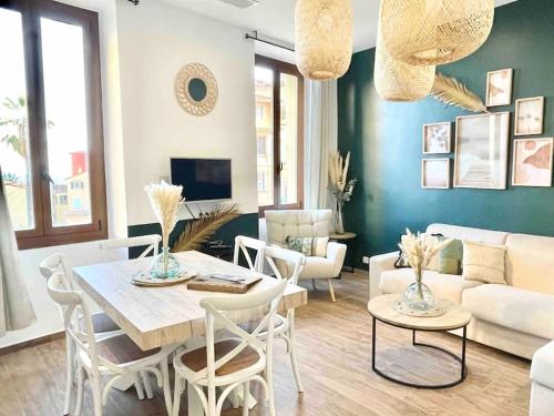 a living room with a table and chairs and a couch at Les Logettes 2 in Menton