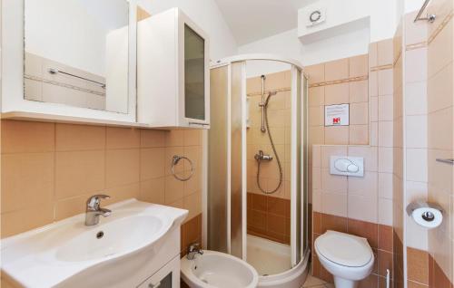 a bathroom with a sink and a toilet and a shower at Amazing Apartment In Fazana With 2 Bedrooms And Wifi in Fažana