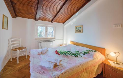 a bedroom with a large bed with flowers on it at Amazing Home In Pobri With House Sea View in Volosko