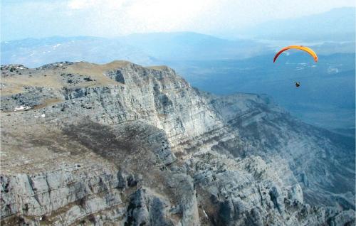 a person flying a kite on top of a mountain at 4 Bedroom Gorgeous Home In Hrvace in Hrvace