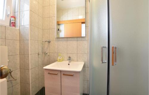 a bathroom with a sink and a shower at Lovely Home In Stanici With House Sea View in Tice