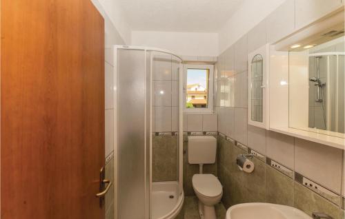a bathroom with a toilet and a glass shower at Pet Friendly Apartment In Biograd With Kitchen in Biograd na Moru