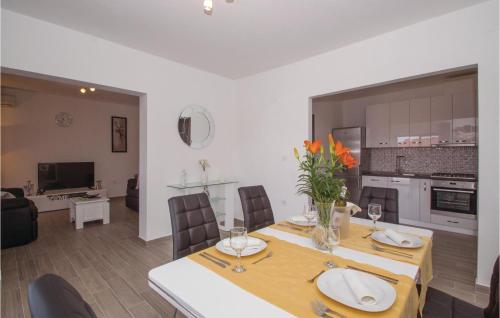 a dining room and kitchen with a table and chairs at Holiday Home Brna V in Brna