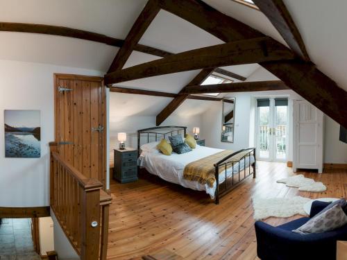 a bedroom with a bed and a wooden floor at Pass the Keys Peaceful & coastal 2 bedroom cottage in Cardigan