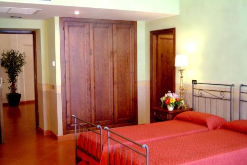 a bedroom with a bed and a wooden closet at Domus Sessoriana in Rome