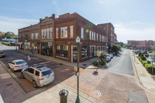 a street with cars parked in front of a building at Sanctuary Co 204 Loft Downtown Johnson City in Johnson City