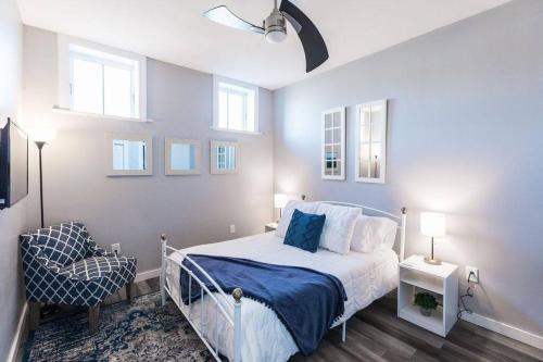 a bedroom with a bed and a chair and windows at The Sanctuary Company Johnson City in Johnson City