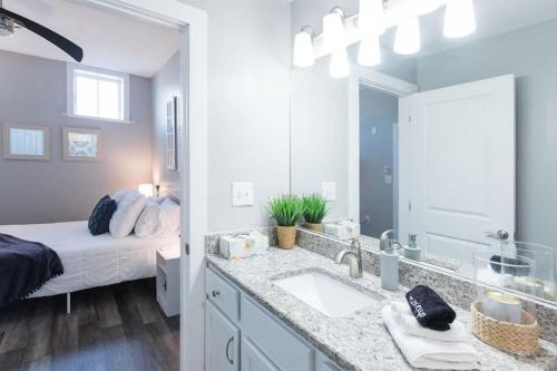 a bathroom with a sink and a bedroom with a bed at The Sanctuary Company Johnson City in Johnson City