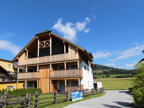 a large wooden house with a fence at Wooden chalet in Mauterndorf near Cross Country Meadows in Mauterndorf