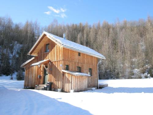 a wooden barn with snow on the ground at Chalet in Stadl an der Mur Styria with terrace in Stadl an der Mur