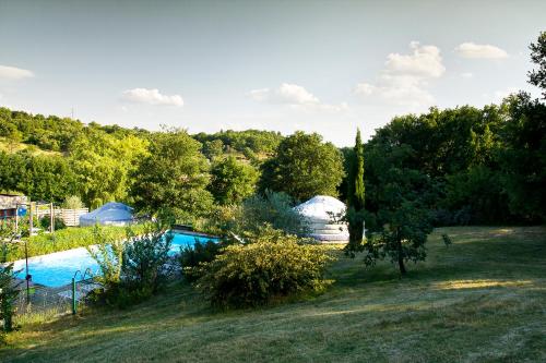 an image of a swimming pool in a field with tents at Natura Lodge in Barjac