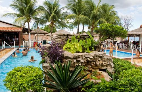 a group of people in a swimming pool at a resort at Hotel Oásis in Açu