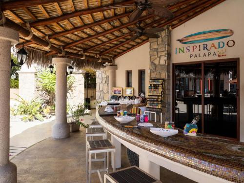 a restaurant with a bar with stools in front of it at Hyatt Vacation Club at Sirena del Mar in Cabo San Lucas