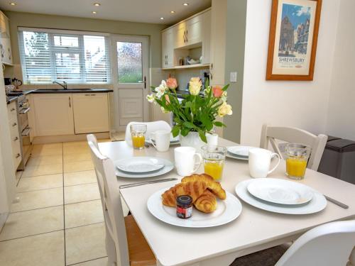 a white table with a plate of food on it at Pass the Keys 3 bedroom home within walking distance of town in Shrewsbury
