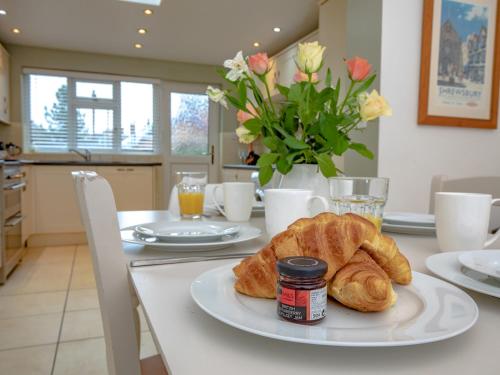 a table with a plate of croissants on it at Pass the Keys 3 bedroom home within walking distance of town in Shrewsbury