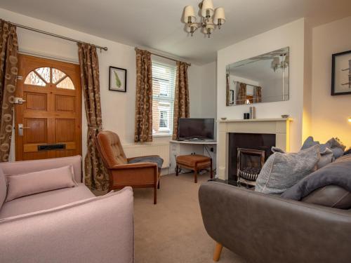 a living room with a couch and a fireplace at Pass the Keys 3 bedroom home within walking distance of town in Shrewsbury