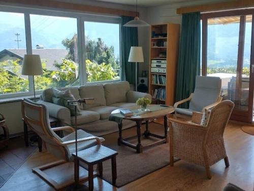 a living room with a couch and chairs and a table at Holiday home in Ludmannsdorf near W rthersee in Ludmannsdorf