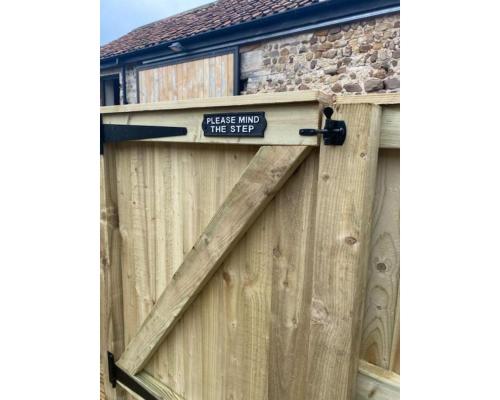 a wooden gate with a sign that reads please enter the step at Swallow Cottage in Ripon
