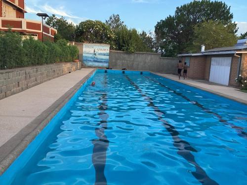a swimming pool with dolphins in the water at Maison entière ChezSoa, antananarivo in Andoharanofotsy