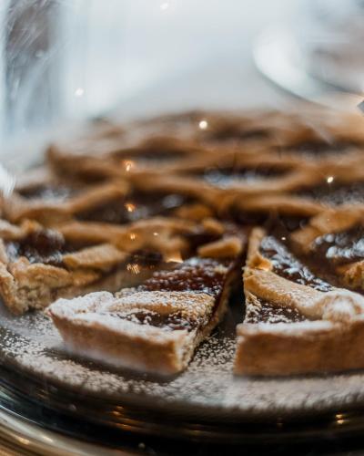 a plate of waffles with powdered sugar on it at Hotel Ristorante Vecchia Riva in Varese