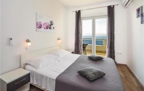 sypialnia z łóżkiem i widokiem na ocean w obiekcie Cozy Home In Krilo Jesenice With House A Panoramic View w mieście Sumpetar
