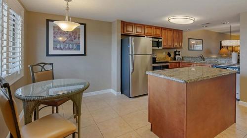 a kitchen with a stainless steel refrigerator and a table at Bluegreen Vacations Orlando's Sunshine Resort in Orlando