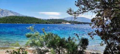 a view of a large body of water with mountains at Beach house Nada in Korčula