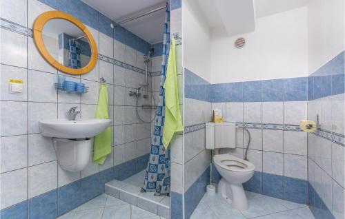 a bathroom with a toilet and a sink at Nice Studio In Labin With Wifi in Diminići